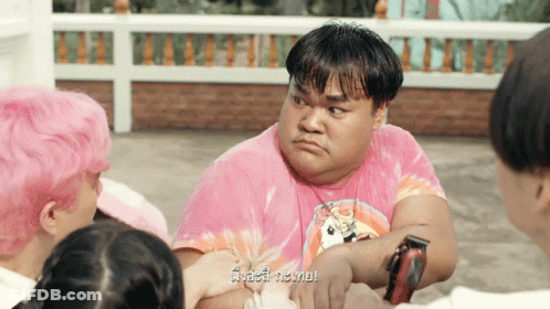 Man In Pink Tie Dye Shirt Surrounded By People GIF