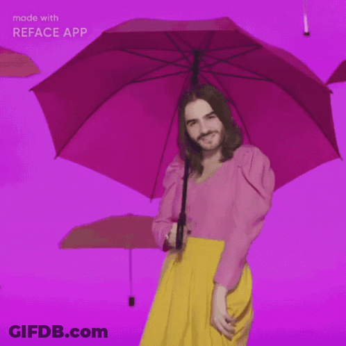 Man In Pink Top And Yellow Skirt Holding Pink Umbrella GIF