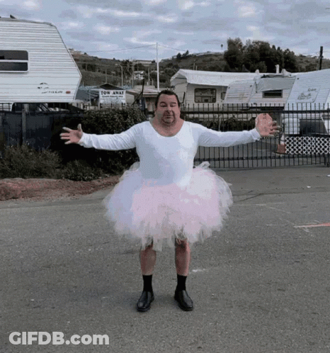 Man In Pink Tutu In Front Of Tow Away Trailer GIF