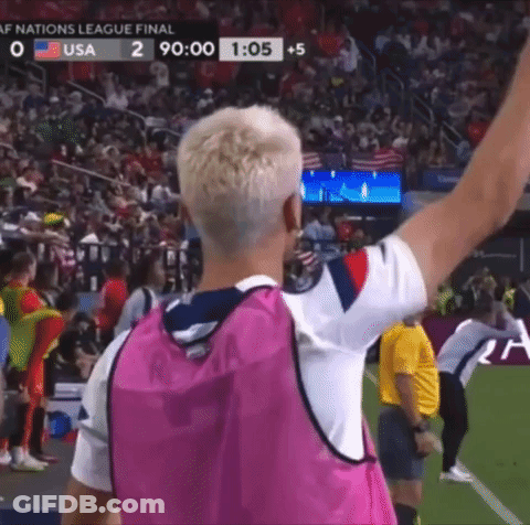 Man In Pink Vest Arm Raised On Soccer Field GIF
