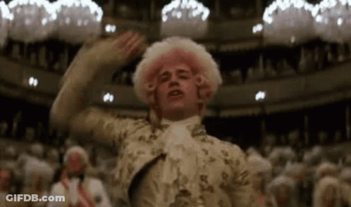 Man In Pink Wig Standing Before Crowd GIF