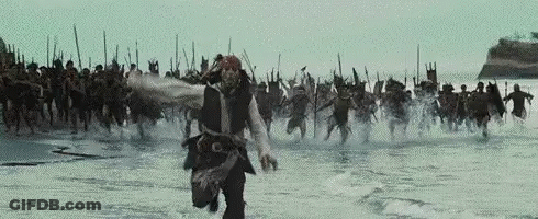 Man In Pirate Costume Running In Water With Group GIF