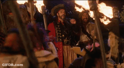 Man In Pirate Costume With Group Holding Torches GIF