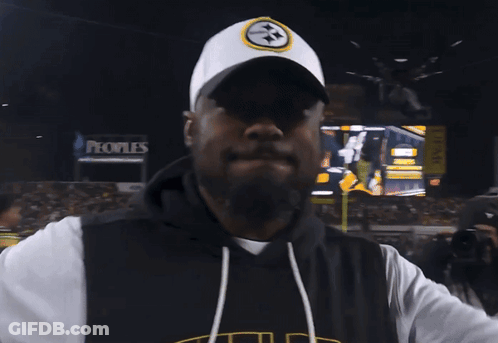 Man In Pittsburgh Hat In Front Of Large Screen GIF