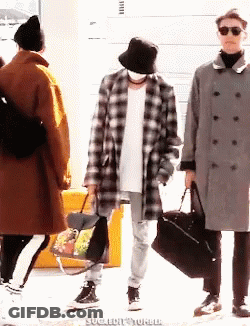 Man In Plaid Coat And Bucket Hat Holding Bag GIF