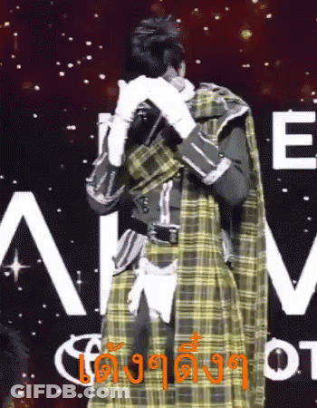 Man In Plaid Coat Covering Face Beside Sign Saying E GIF