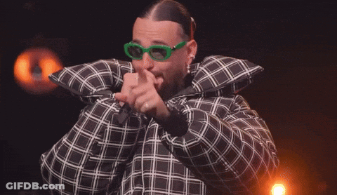 Man In Plaid Jacket And Green Glasses Holding Microphone GIF