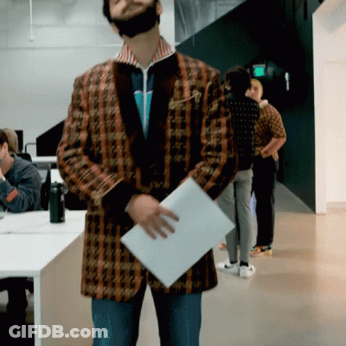 Man In Plaid Jacket Holding Paper GIF