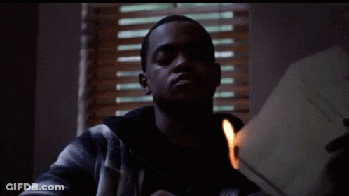 Man In Plaid Jacket Lighting Paper With Match GIF