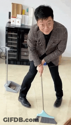 Man In Plaid Jacket Sweeping With Blue Broom GIF