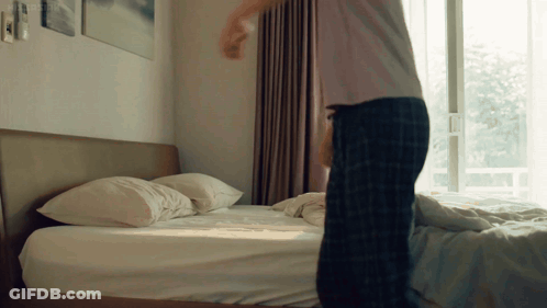 Man In Plaid Pajamas Standing On Bed GIF