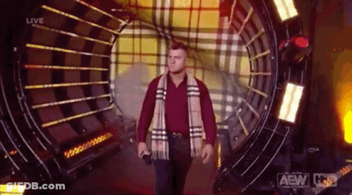 Man In Plaid Scarf And Red Shirt Walking Through Tunnel GIF