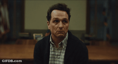 Man In Plaid Shirt And Black Jacket Facing Camera GIF