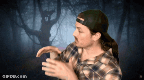 Man In Plaid Shirt And Cap In Front Of Tree GIF
