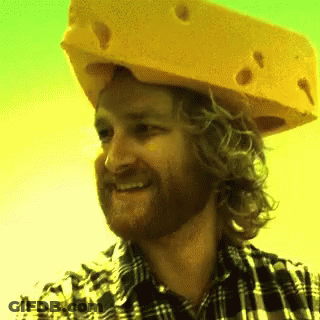 Man In Plaid Shirt And Cheese Hat Smiling GIF