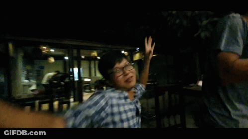 Man In Plaid Shirt And Glasses Dancing In Dark Room GIF