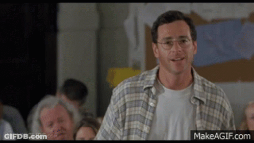Man In Plaid Shirt And Glasses Faces Crowd GIF