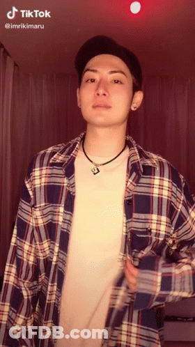 Man In Plaid Shirt And Hat With TikTok Sticker On Face GIF