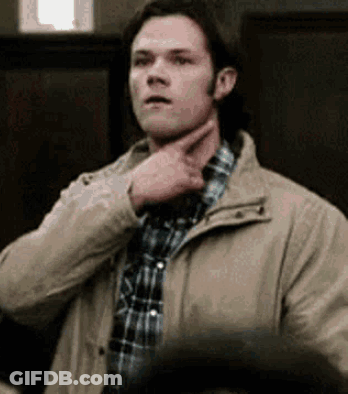 Man In Plaid Shirt And Jacket Holding Chin GIF