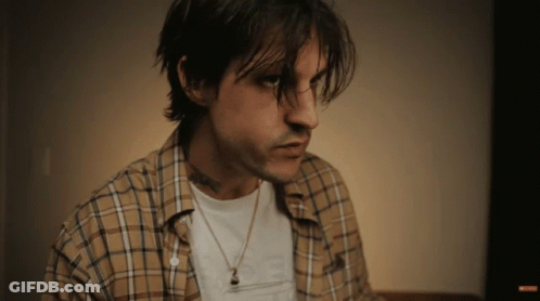 Man In Plaid Shirt And Necklace With I Love You Tattoo GIF
