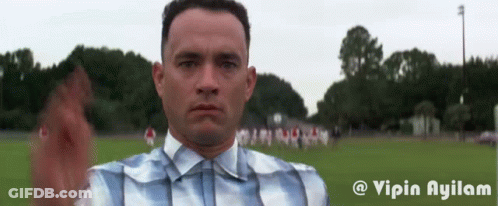 Man In Plaid Shirt And Suspenders In Field GIF