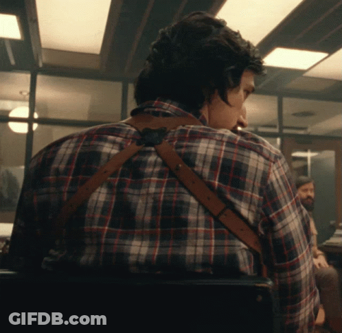 Man In Plaid Shirt And Suspenders Looking Over Shoulder GIF