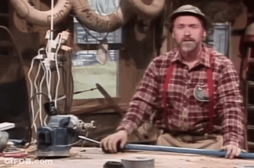 Man In Plaid Shirt And Suspenders Working On Pipe GIF