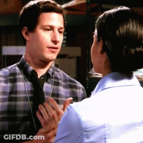 Man In Plaid Shirt And Tie Talking To Woman In Blue Shirt And Tie GIF