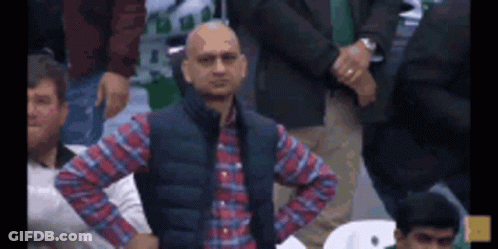 Man In Plaid Shirt And Vest Standing GIF
