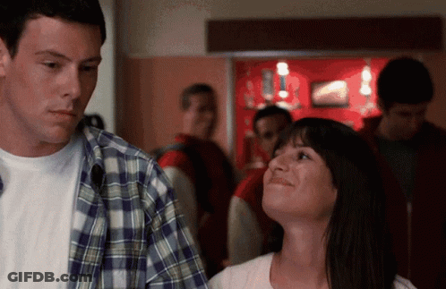 Man In Plaid Shirt And Woman In White Shirt Standing Together GIF