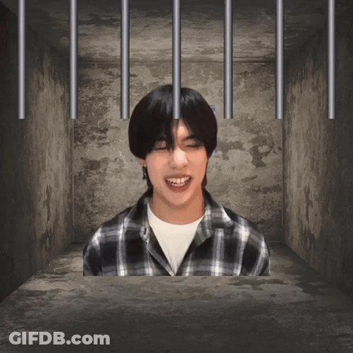 Man In Plaid Shirt Behind Bars GIF