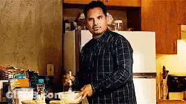 Man In Plaid Shirt Cooking In Kitchen GIF
