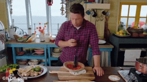 Man In Plaid Shirt Cooking In Kitchen GIF