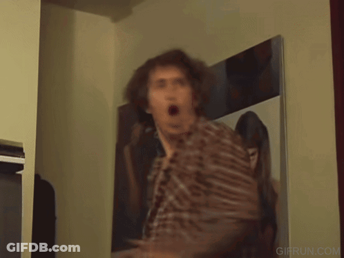 Man In Plaid Shirt Dancing In Front Of TV GIF