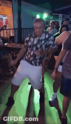 Man In Plaid Shirt Dancing On Green Floor GIF