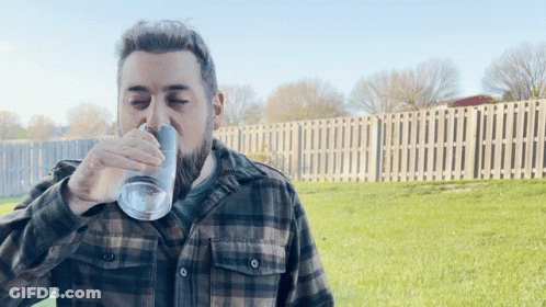 Man In Plaid Shirt Drinking From Glass GIF