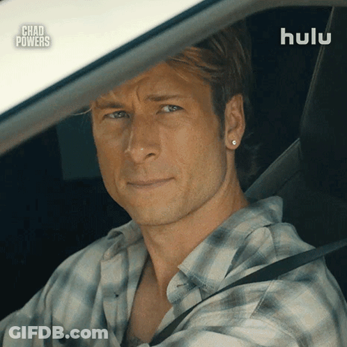 Man In Plaid Shirt Driving Car With Hulu Logo GIF