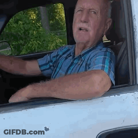 Man In Plaid Shirt Driving White Truck GIF