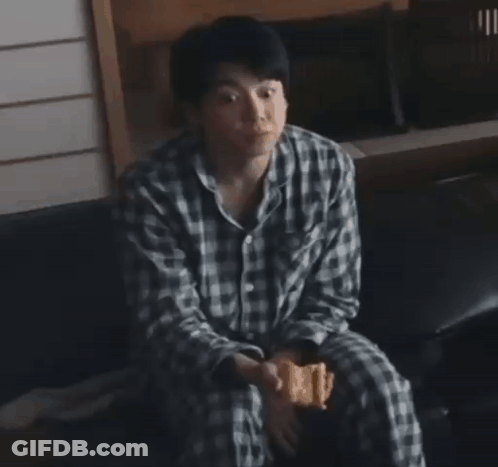Man In Plaid Shirt Eating Snack GIF