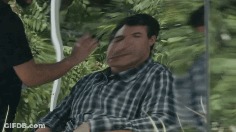 Man In Plaid Shirt Eyes Closed Green Background GIF