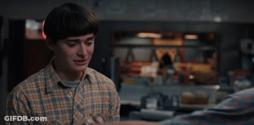 Man In Plaid Shirt Holding Another Man's Arm GIF