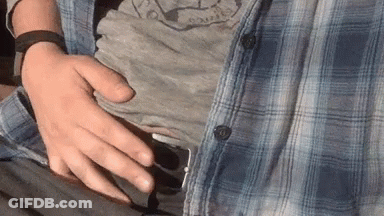 Man In Plaid Shirt Holding Belly GIF