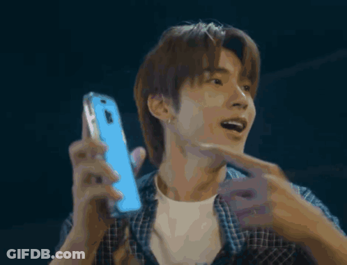 Man In Plaid Shirt Holding Blue Phone GIF