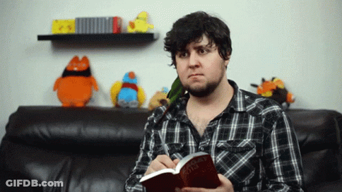 Man In Plaid Shirt Holding Book The Hobbit GIF