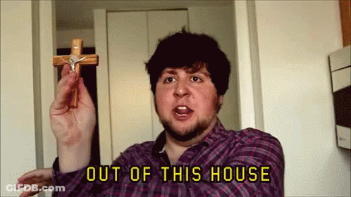 Man In Plaid Shirt Holding Cross Out Of This House GIF