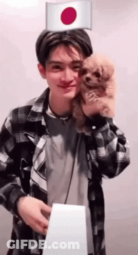 Man In Plaid Shirt Holding Dog With Japanese Flag GIF