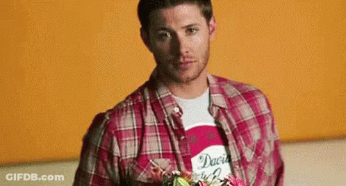 Man In Plaid Shirt Holding Flowers GIF