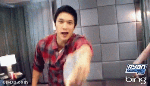 Man In Plaid Shirt Holding Frisbee In Front Of Bing Ad GIF