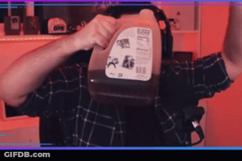 Man In Plaid Shirt Holding Gallon Of Milk GIF