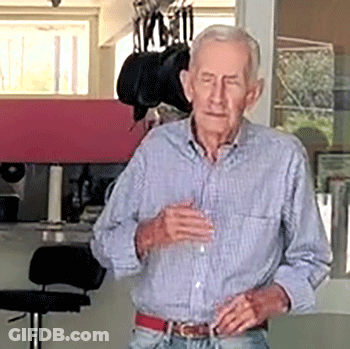 Man In Plaid Shirt Holding Glass GIF